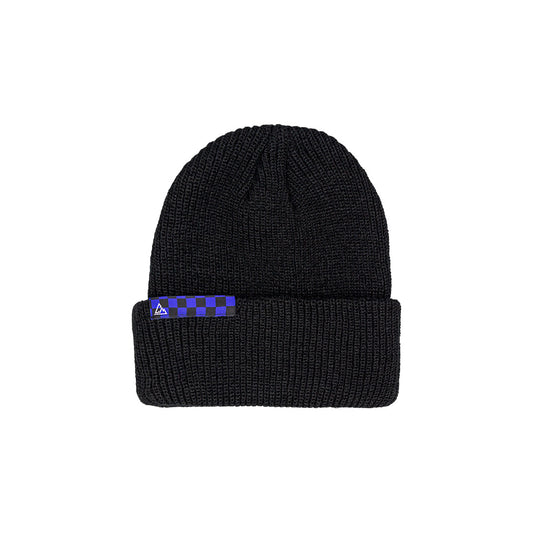 A black knitted beanie with a ribbed pattern, featuring a blue and black checkered patch on the folded cuff with a small triangular logo.