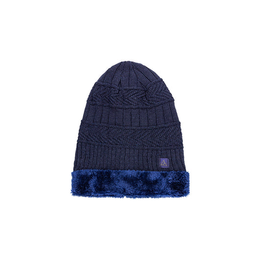 A navy blue heavy knit beanie with a detailed cable knit pattern, a ribbed fold-over cuff, and a band of fluffy blue faux fur. The beanie is finished with a small triangular logo on the cuff.