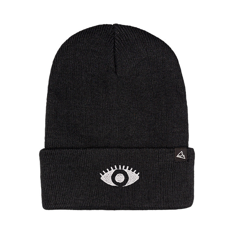 A black ribbed beanie with a white eye patch on the fold and a small triangular logo patch.