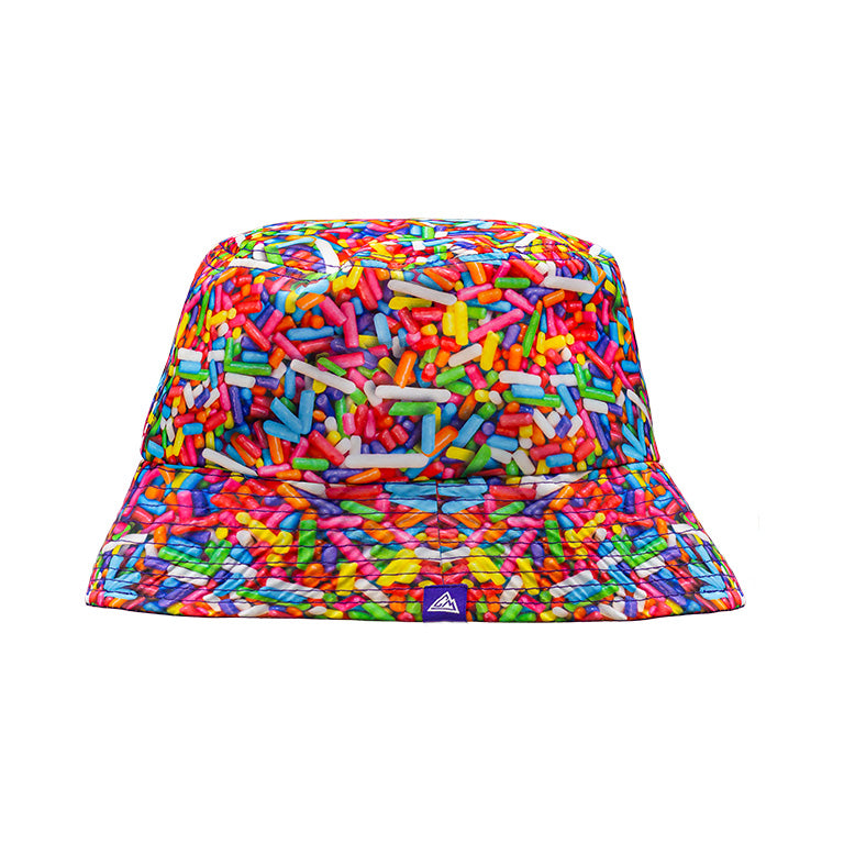Floppy bucket hat with a bright, colorful print of rainbow sprinkles covering the entire surface.