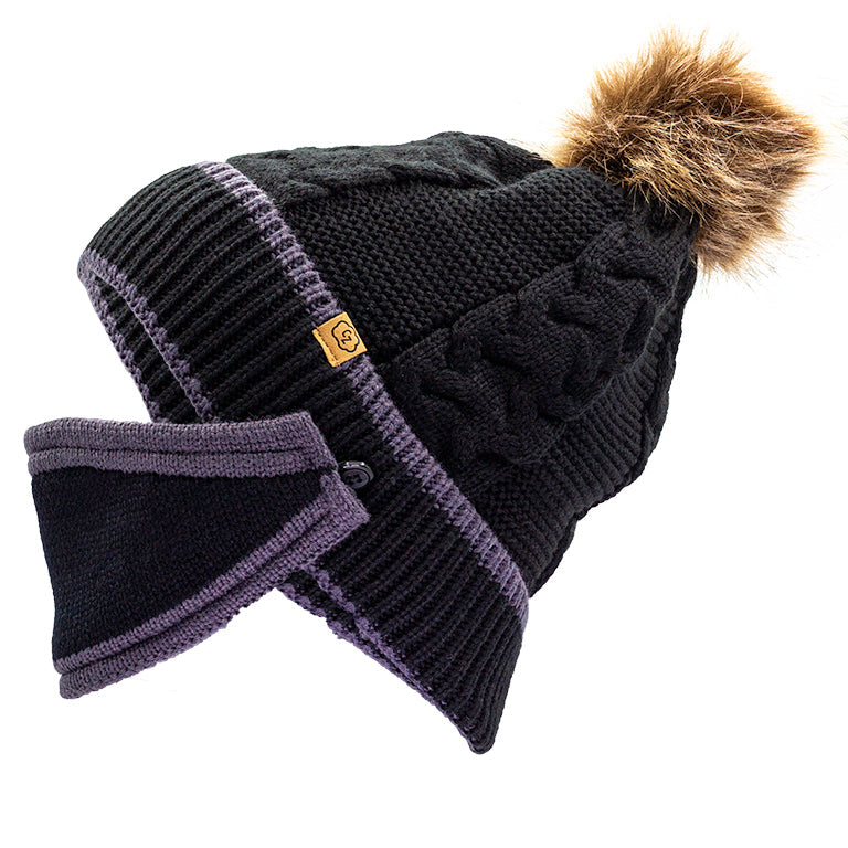 A side profile of a solid black beanie featuring a cable knit pattern, accented with a brown faux fur pom-pom, and includes a black mask with gray trim.