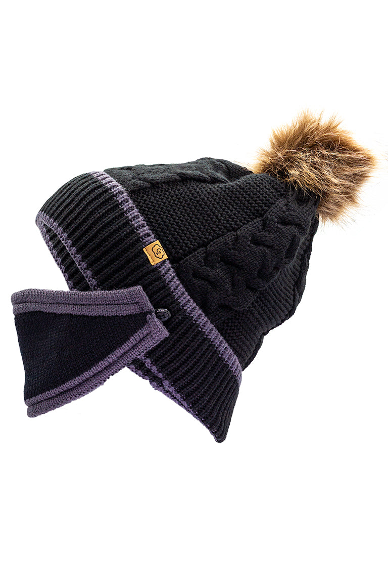 A side profile of a solid black beanie featuring a cable knit pattern, accented with a brown faux fur pom-pom, and includes a black mask with gray trim.